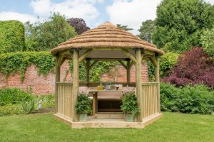 Forest Garden 3.6m Hexagonal Wooden Garden Gazebo with Thatched Roof - Furnished with Table, Benches and Cushions  (Cream)