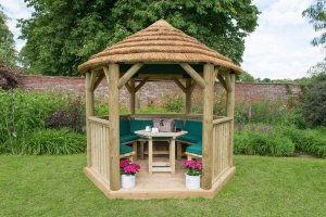 Forest Garden 3m Hexagonal Wooden Garden Gazebo with Thatched Roof - Furnished with Table, Benches and Cushions (Green)