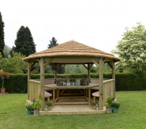 Forest Garden 4.7m Hexagonal Wooden Garden Gazebo with Thatched Roof - Furnished with Table, Benches and Cushions (Cream)